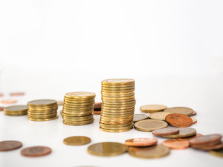 Thai Baht Coins colors Gold set in the mountains,Is the currency of Thailand.For business expenses,Coin is in a jar of money saving,White background