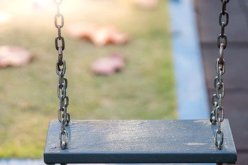 Wooden swing at playground.