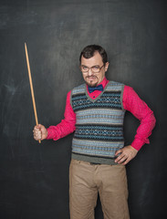 Angry teacher in retro style with pointer on blackboard