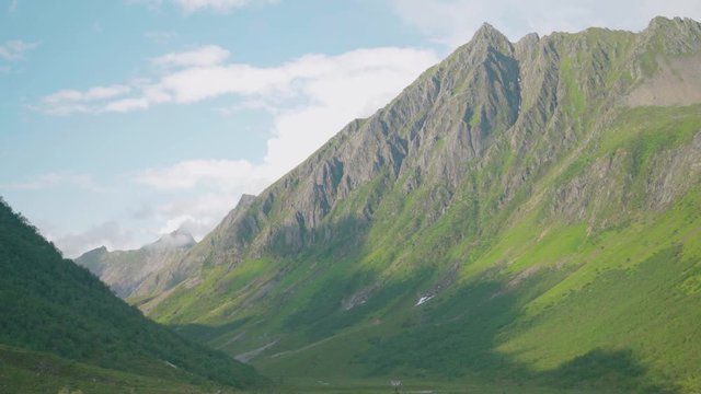 small red cabin surrounded by big majestic mountains - the great norwegian nature