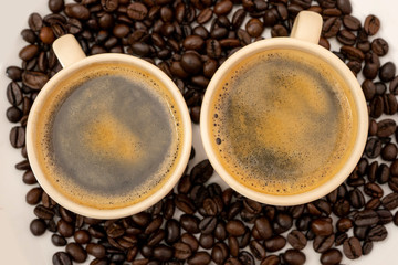 Top view of coffee cup with coffee beans on white background