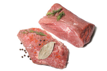 a piece of meat with seasonings on a wooden table