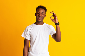 African guy showing ok sign and widely smiling