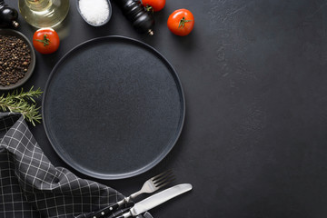 Backdrop with black dish,tomatoes, spices and ingredients for cooking tasty Pasta or pizza. Copy space. View from above.