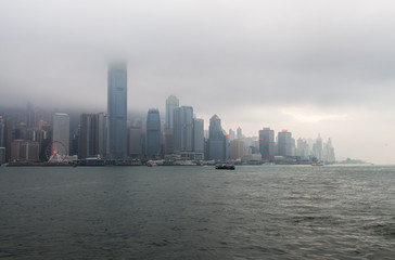 Fototapeta na wymiar Hong Kong boats sail against Wan Chai district
