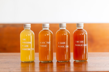 bottle of Kombucha variety probiotic drink on wooden table background.