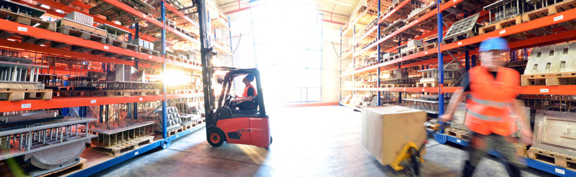 logistics and transport workers in a goods warehouse with goods for storage and shipping