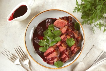Duck breast in blackberry sauce. Homemade organic food.