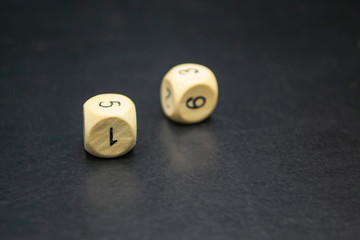 Two cubes with numbers on a black background