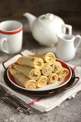Homemade thin pancakes with sweet cream.