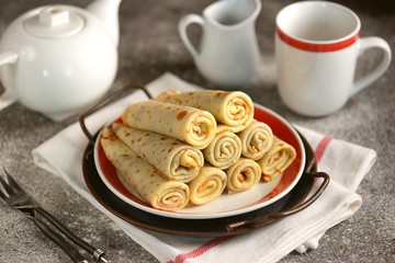 Homemade thin pancakes with sweet cream.