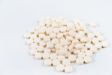 Medicine pills concept on gray background. A lot of round pills on a white background close-up and copy space.