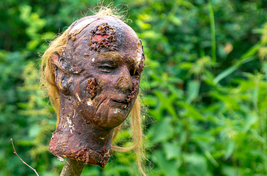 Latex creepy head impaled on a stake at a medieval festival
