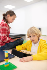 Pupils sitting with their tablets, studying something