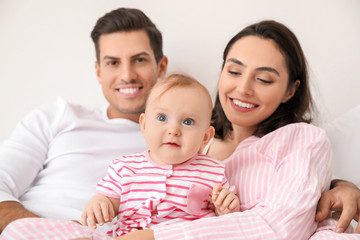 Cute baby with parents at home