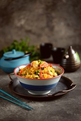 Fried rice with green peas, shrimp, chicken, onions, soy sauce and hot pepper. Healthy food.
