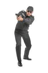 Male police officer with gun on white background