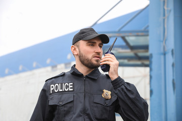 Male police officer patrolling city street