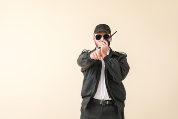 Male police officer on color background