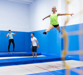 Female gymnast jumping on trampoline