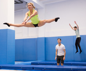Woman jumping in trampoline center