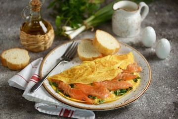 Omelet with green onions, parsley and salted salmon. Healthy food.