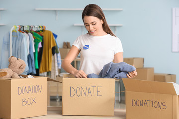 Volunteer with donations for poor people indoors
