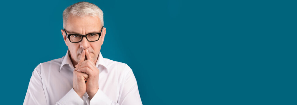 Senior man portrait on dark blue background