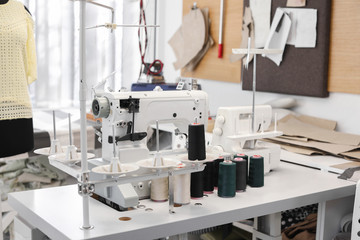 Modern sewing equipment in tailor workshop
