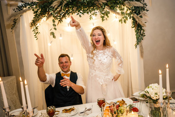 wedding couple bride and groom sit at a table in a restaurant