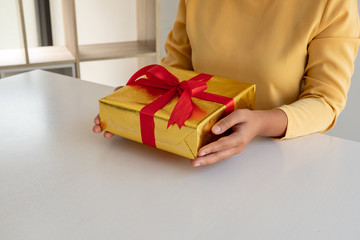 Female hands holding gift box Christmas and New year gift