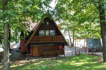 Fototapeta na wymiar wooden eco country house in forest near lake