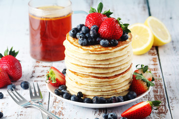 A stack if home-made pancakes with berry