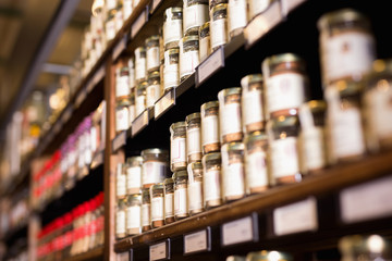 Spices in glass jars at store