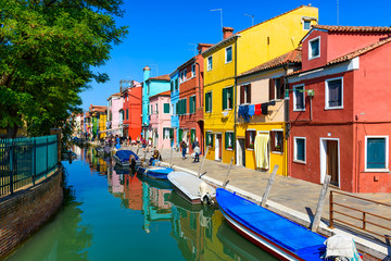 Street with colorful buildings and canal in Burano island, Venice, Italy. Architecture and landmarks of Venice, Venice postcard