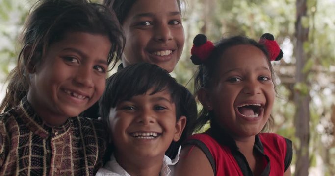 Friends like brothers sisters children together having a good time looking straight at camera as they play and enjoy each other's company and pose for photo video looking adorable, cute mischievous