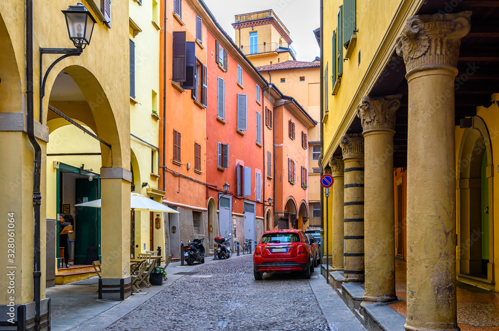 Wall mural old narrow street with arcade in bologna, emilia romagna, italy. architecture and landmark of bologn