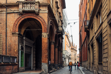 Old narrow street with arcade in Bologna, Emilia Romagna, Italy. Cityscape of Bologna.