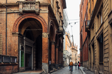 Old narrow street with arcade in Bologna, Emilia Romagna, Italy. Cityscape of Bologna. © Ekaterina Belova