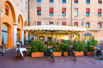 Piazza del Municipio with tables of restaurant in Ferrara, Emilia-Romagna, Italy. Ferrara is...