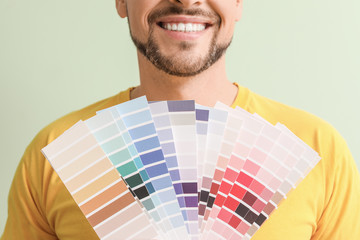 Man with color palettes on green background