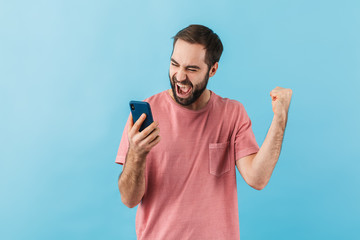 Portrait of a young cheerful bearded man wearing t-shirt