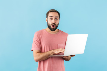 Portrait of a young cheerful bearded man wearing t-shirt