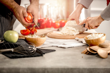 preparation of dishes on a wooden kitchen table in the light of the Tuscan sun