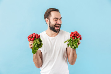 Portrait of a young cheerful bearded man wearing t-shirt