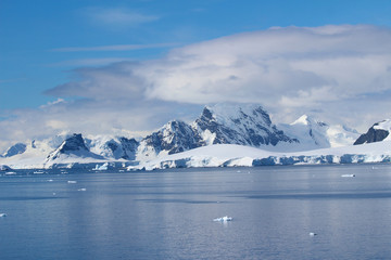 Fototapeta na wymiar Mountains of the Antarctic Peninsula. The mountains in the Bismarck Strait at the entrance to Flandres Bay, Antarctica