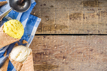 Set of various homemade colorful ice cream with icecream waffle cones on wooden background, copy space top view