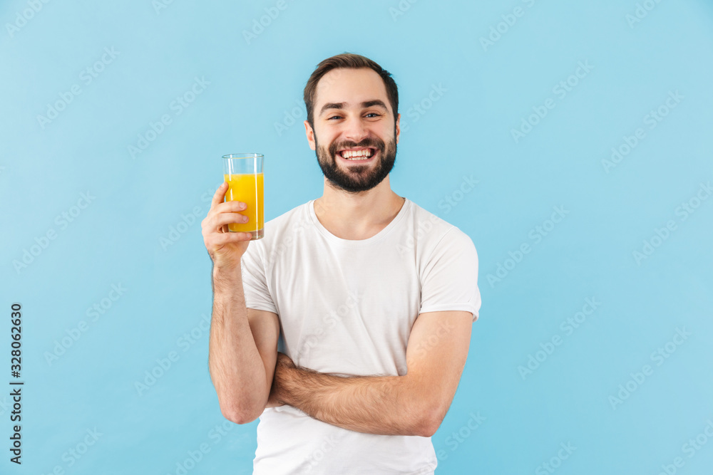 Wall mural handsome young bearded man wearing t-shirt standing