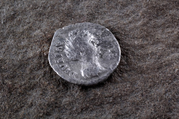 Ancient Roman coin on stone