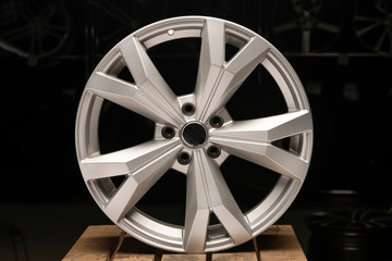 silvery new cast aluminum wheels on a black background close up